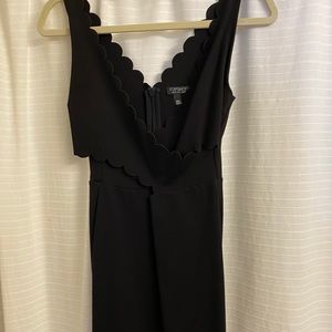 Scalloped black minidress with cutouts